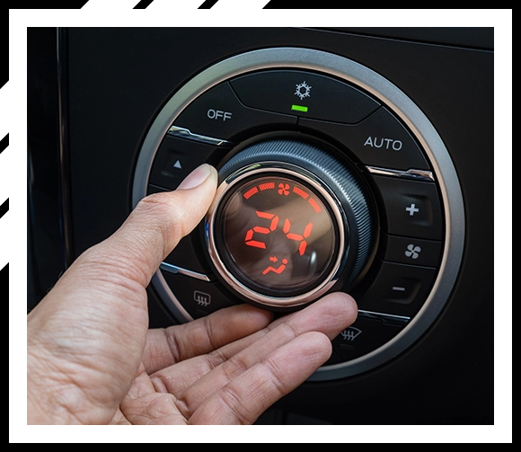 Person's hand turning on car AC, Car interior